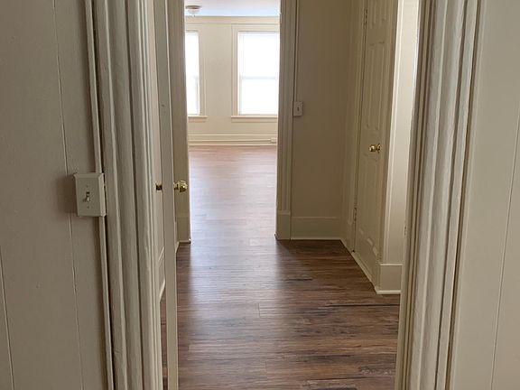 View from bedroom into hallway and living room.