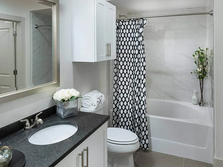 Contemporary bathroom with several storage cabinets