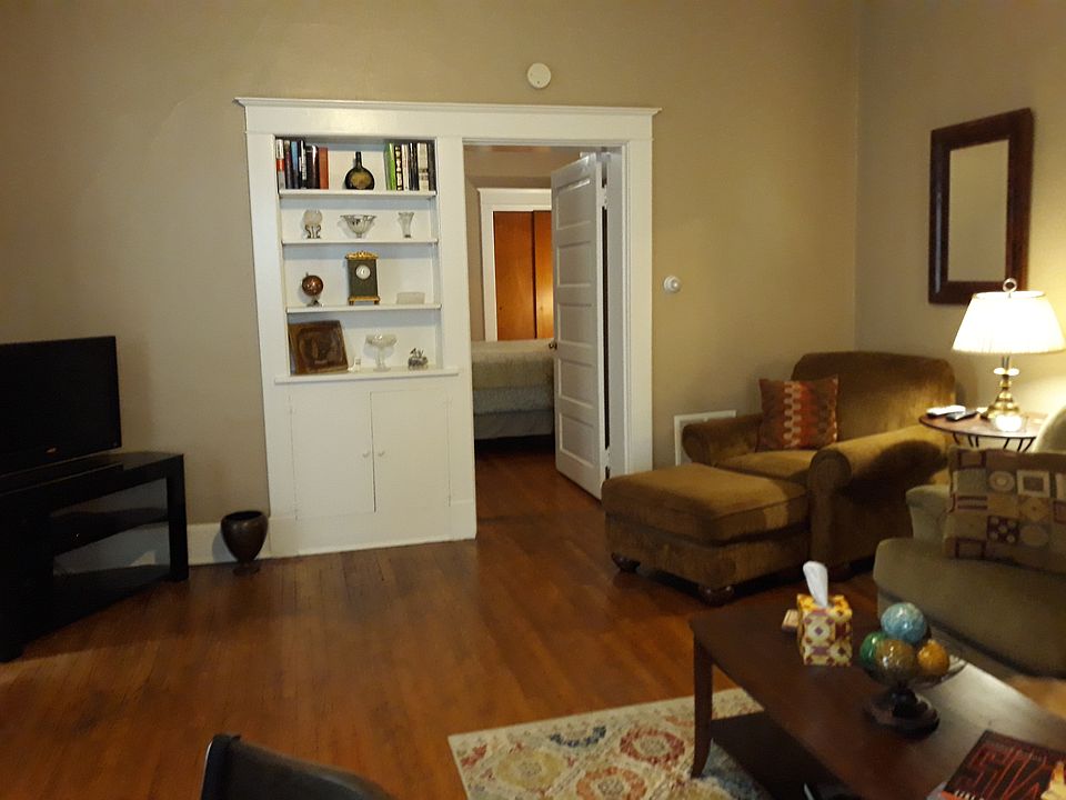 Living Room view into Bedroom. Nice built in bookshelfs and bottom cabinet with shelf and doors.