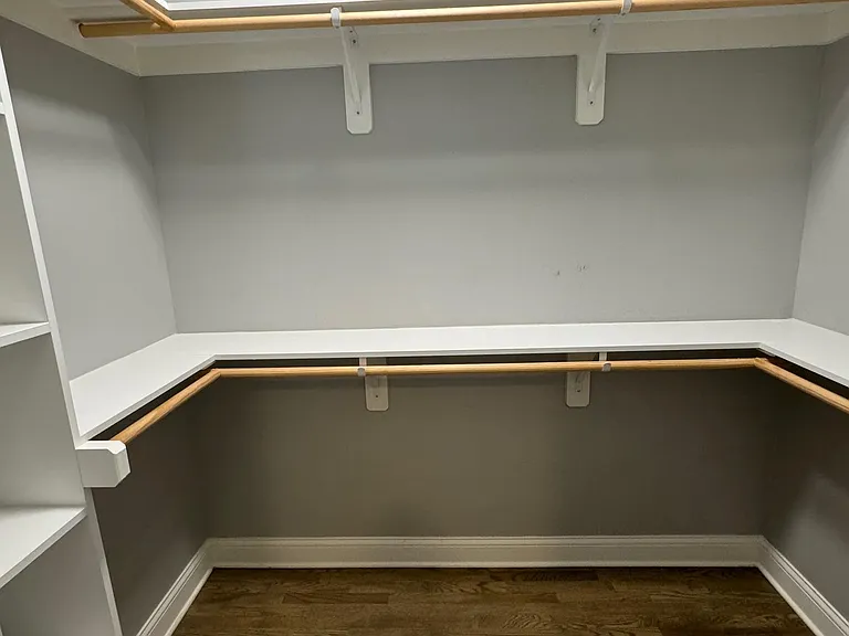 Large walk in closet with shelves. Plenty of storage.