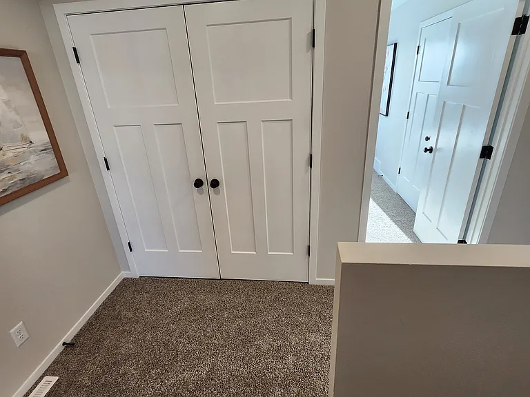 Laundry space directly off the upstairs landing. (Pictures are of another unit with similar finishes and features.)