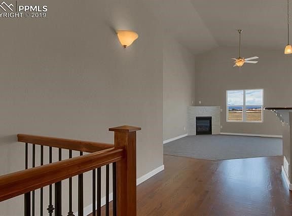 Huge Great Room with High Vaulted Ceiling, custom Gas Fireplace, and views of Pikes Peak and Mountains.