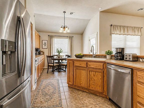 Large kitchen with lots of cabinets, storage space and breakfast bar. Full size refrigerator included