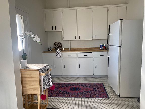 kitchen. door to private balcony located on left. Not pictured is entry to walk-in pantry (located next to fridge)