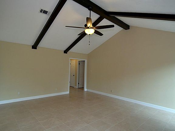 The ceiling in the family room has stunning wood beams.