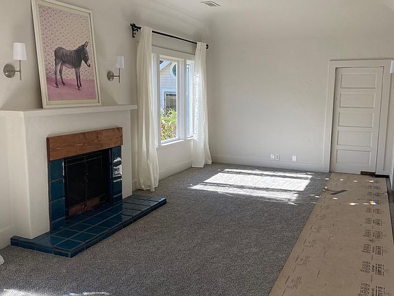 Front room which gets beautiful southern light. Windows have original stain glass panels.
