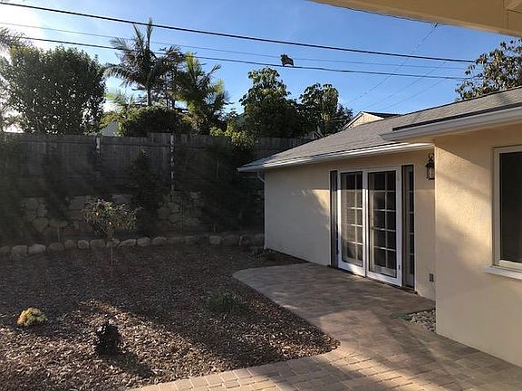 Back yard, with multiple patio spaces. Pavers and flagstones.