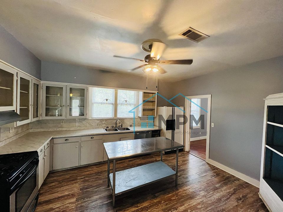Kitchen with all appliances, original glass front cabinets, kitchen island and antique storage cabinet.