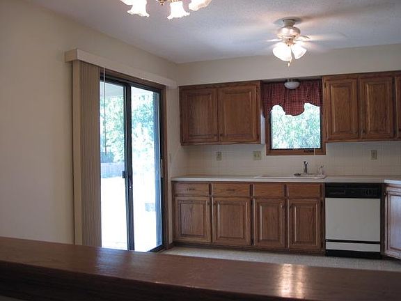 Sliding door exits from kitchen to covered patio