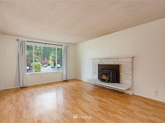 Living room has a wood-burning stove with a new chimney