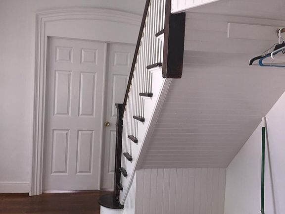 Entrance and staircase with rich wood floors