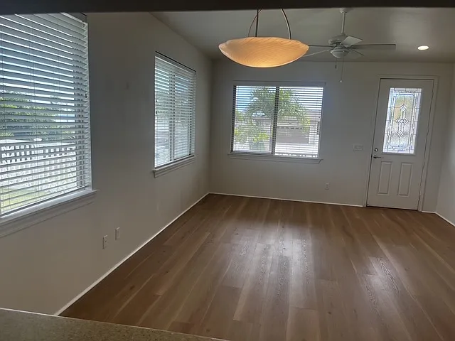 Living room with vaulted ceiling and Murano glass chandelier from the kitchen pass through counter