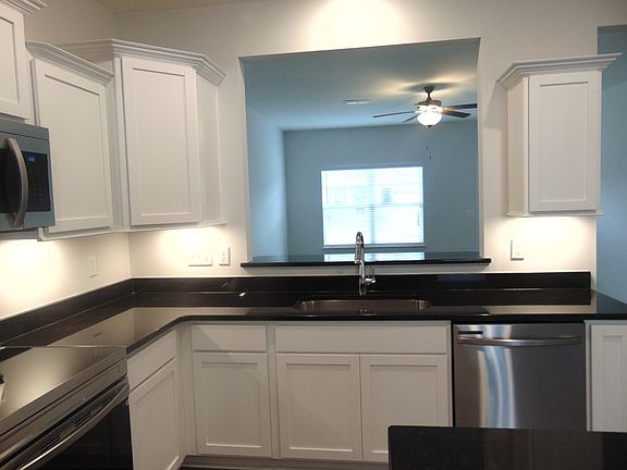 he kitchen is spacious and modern, it comes with steel appliances, and crown cabinetry for a unique