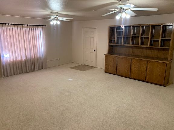 Extra enclosed garage space for multi-use with built-in custom cabinetry.