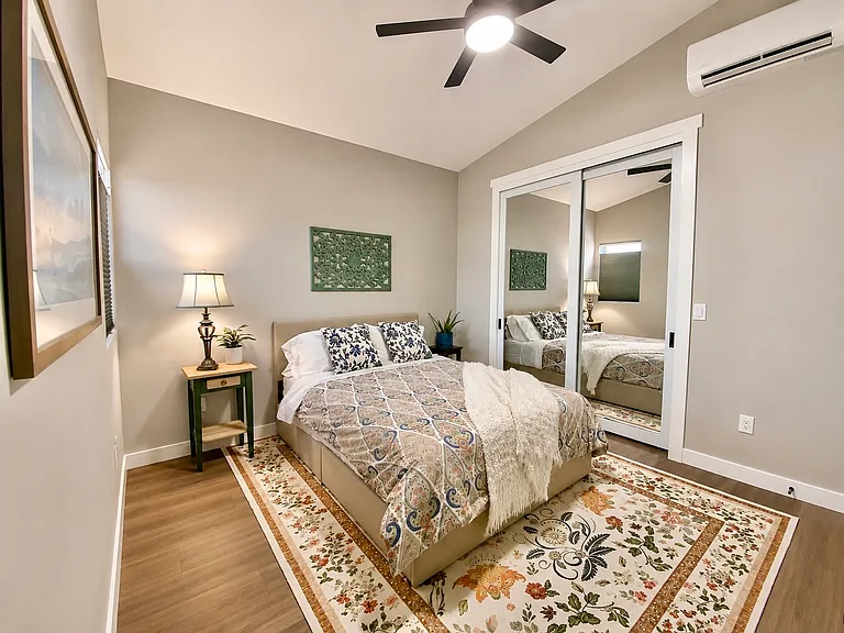 8-foot mirrored closet for clothing and extra shelves for storage. Programmable multi-speed ceiling fan with dimmable warm/cool/white light.
