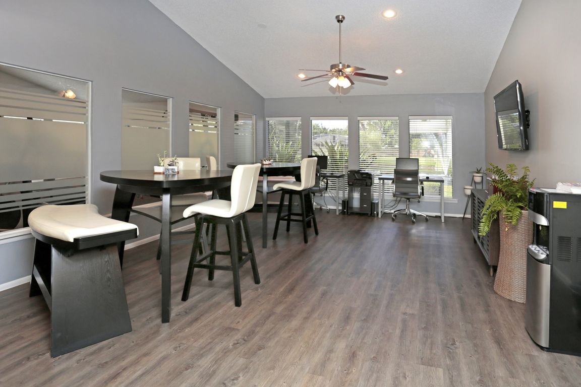 Spacious resident lounge with workstations, cafe seating, and plenty of natural light _ perfect for remote work, casual meetings, or unwinding with neighbors.