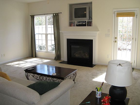 Living room with fireplace (wooded lot behind with patio)
