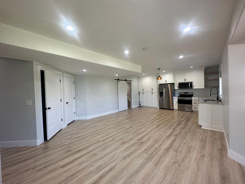 Living area/kitchen sliding door leads to half bath & laundry room