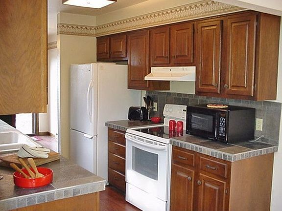 Kitchen with New Tile Counter Tops, Refrigerator, Stove & Vent Hood
