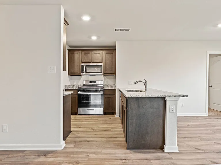 The kitchen has beautiful wood cabinetry.
