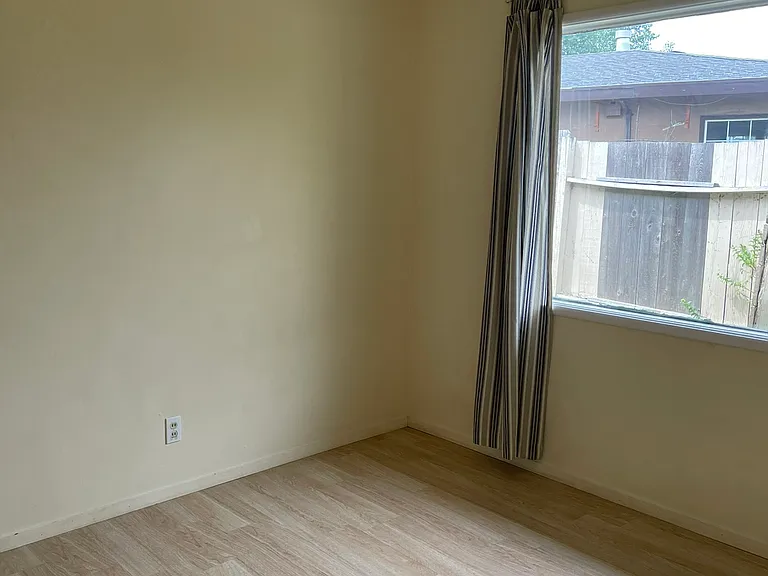 Sunny Bedroom 1 with Double-Paned Windows and Window Coverings