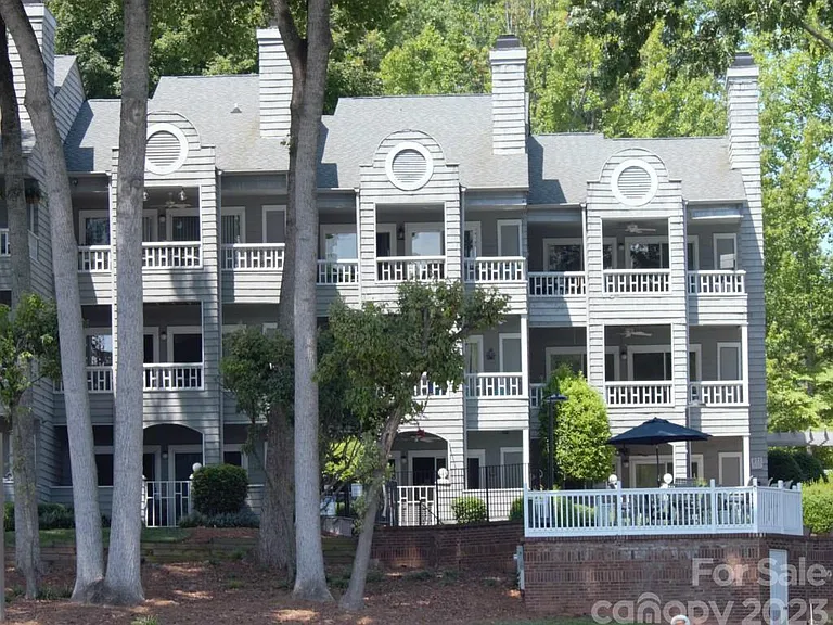 Exterior back view from Lake Norman. Unit is center, top level