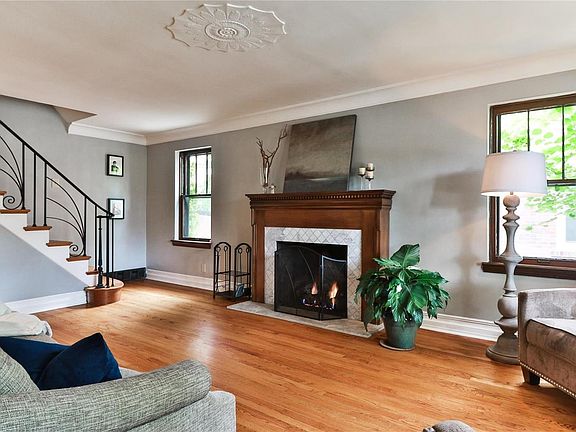 Another view of the living room highlighted by the traditional fireplace