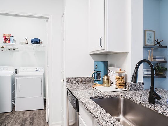 Renovated kitchen with stylish designer tile backsplash and granite countertops