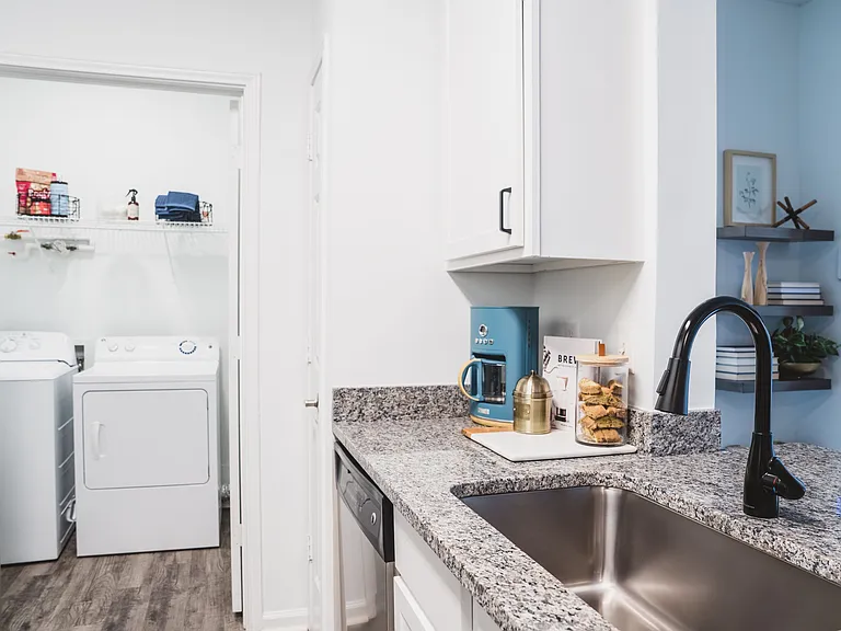Renovated kitchen with stylish designer tile backsplash and granite countertops