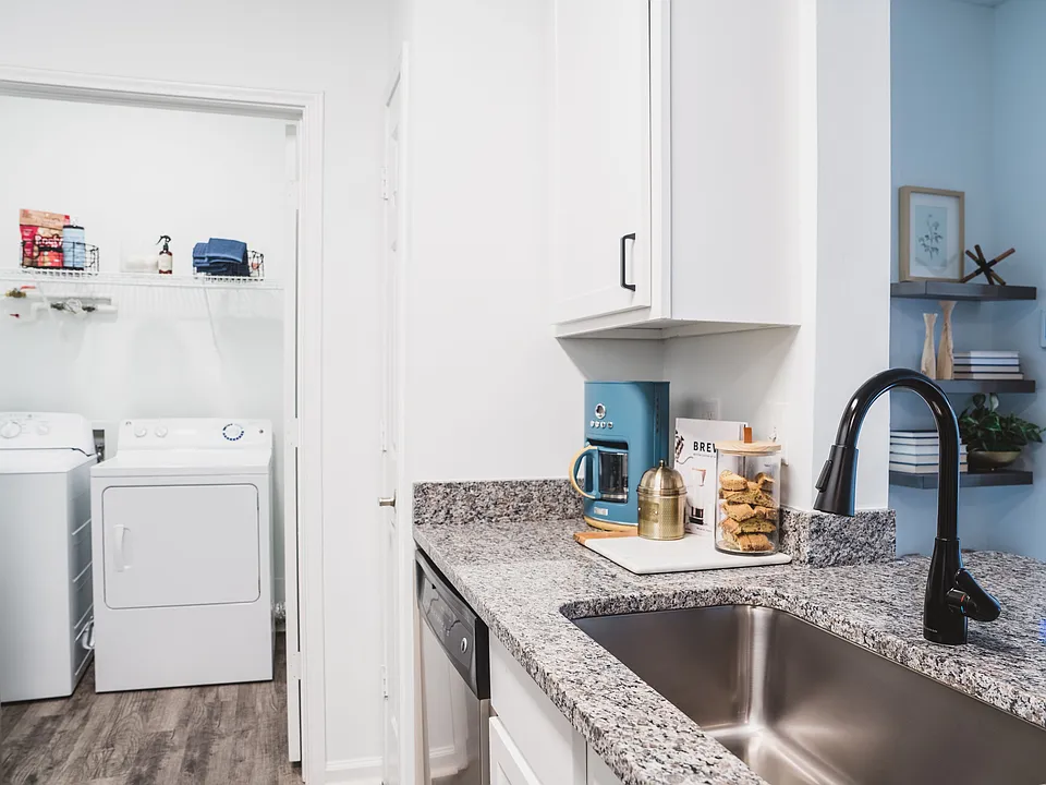 Renovated kitchen with stylish designer tile backsplash and granite countertops