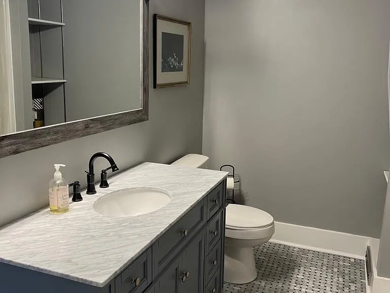 Fully renovated bathroom with tub shower and laundry on the first floor