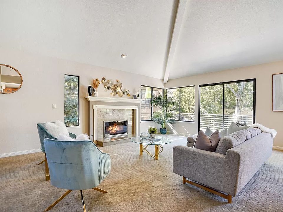 Living room (family room) with a beautiful fireplace and a spacious balcony