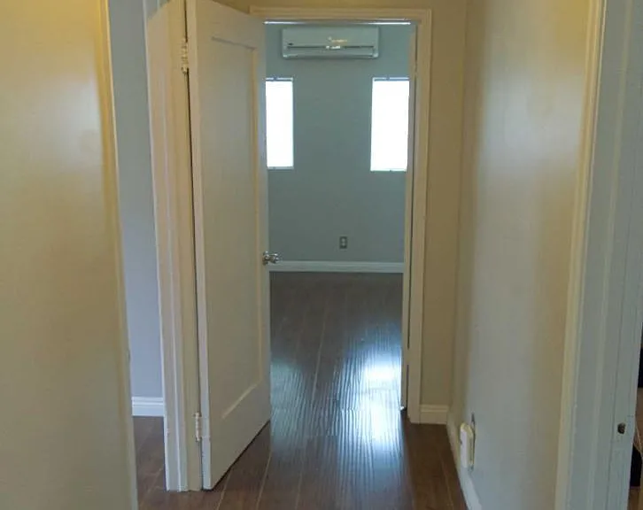 Hallway with access to bedrooms and kitchen