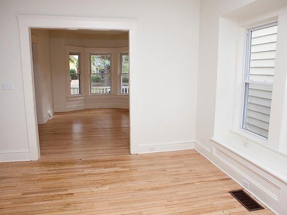 Dining room with window seat and refinished hardwood floors,