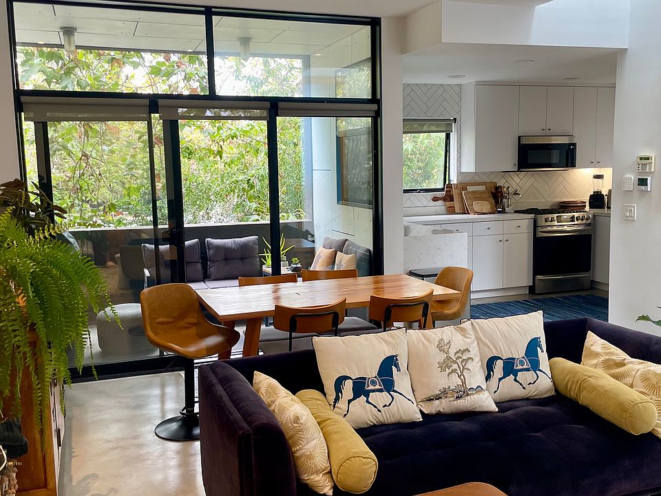 Open living, dining, kitchen + patio w/ gas grill