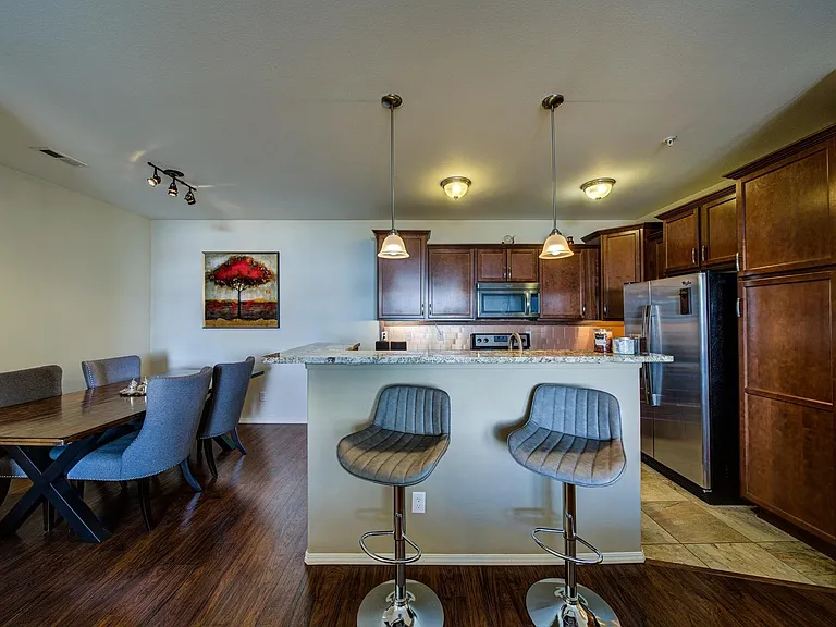 Granite kitchen counter makes a convenient breakfast bar.