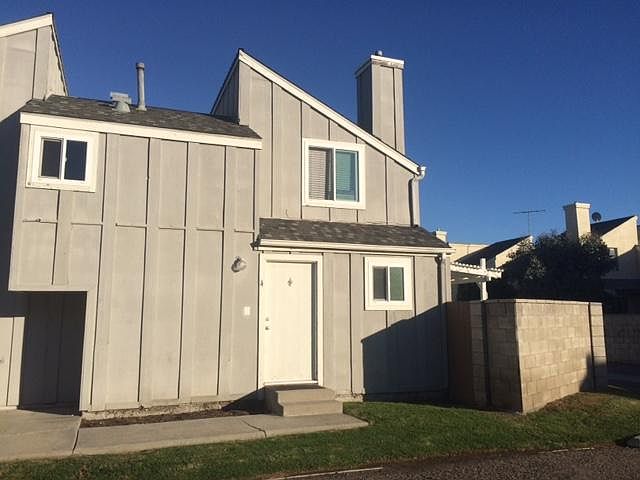 front door and gated block wall to yard
