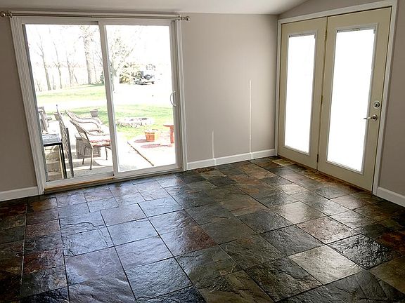Sunroom has large screened door to private patio and large s