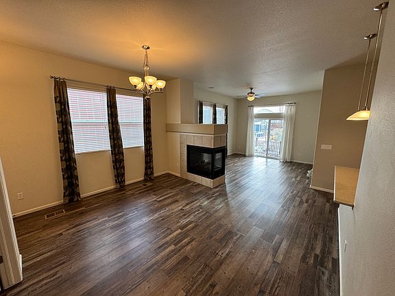Viewpoint from hallway entrance into the seating area and living room space. 10 foot ceilings and multiple windows for plenty of light.