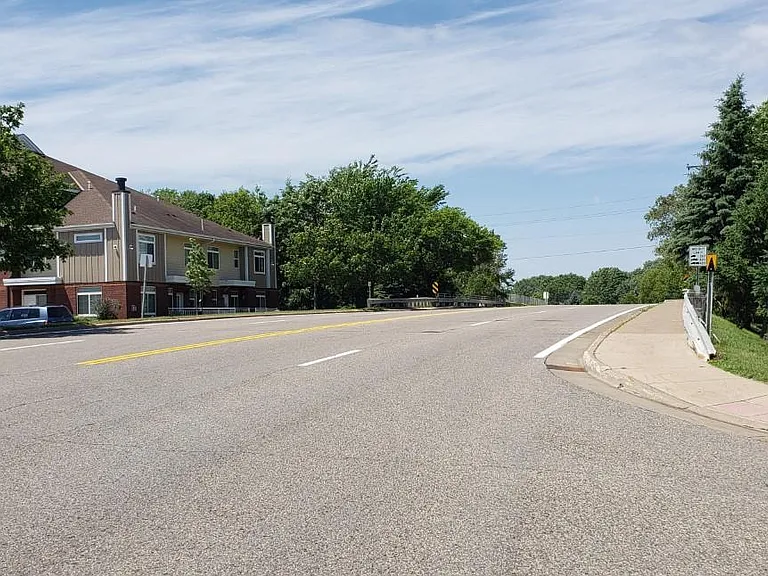 End view shows sidewalk opposite the condos for an additional leisure walk over the bridge