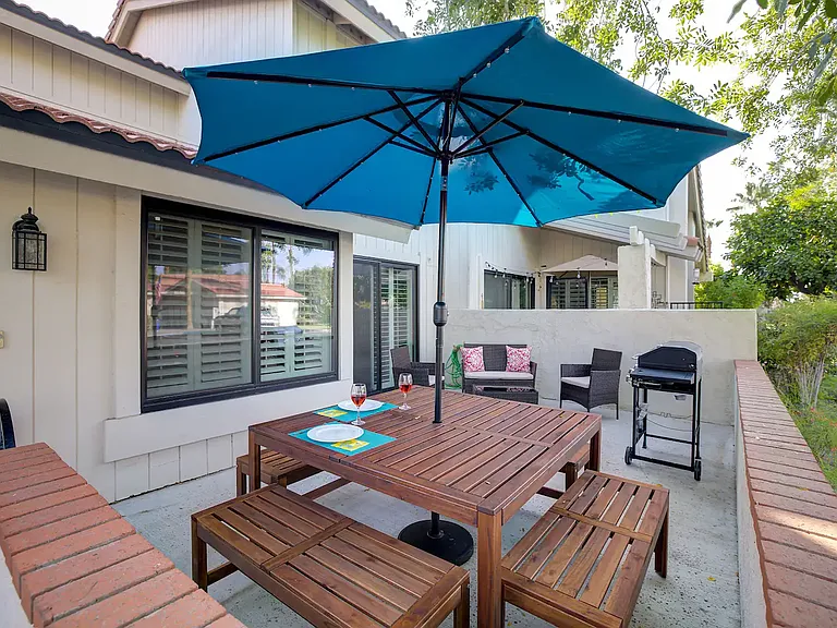 Front patio area ... plenty of space for all guests. Seating for 8. Umbrella contains solar lights.