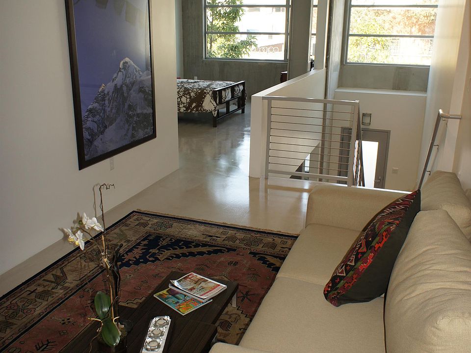 Upper level living space configured as livingroom/TV room with bedroom in background