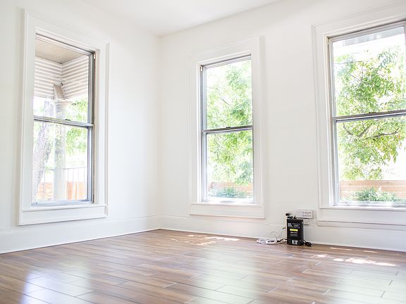 Bedroom looks out onto enormous trees.