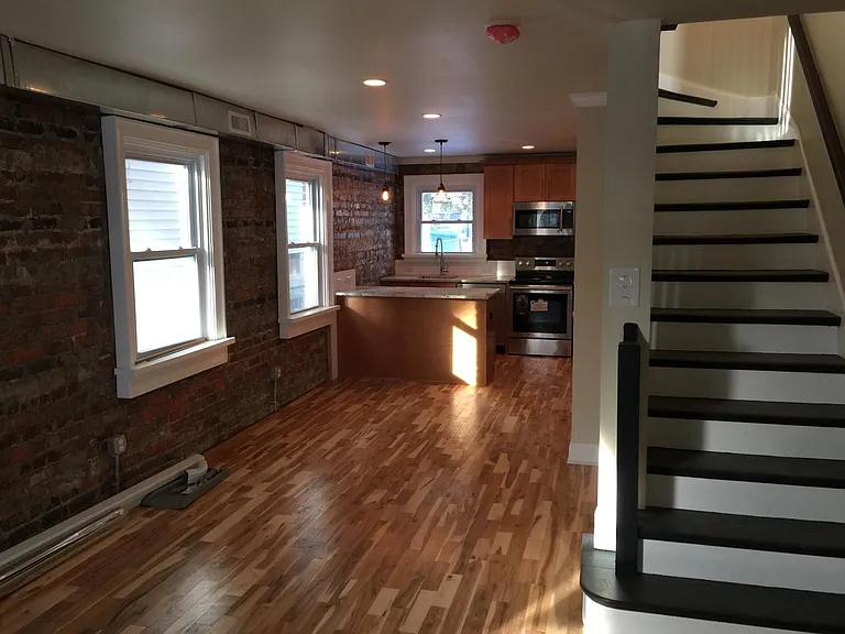 View from front entrance looking into kitchen. Open first floor. Powder under stairs.