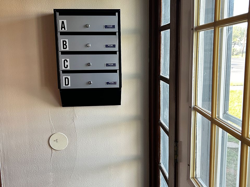 Entryway - interior mailboxes and package delivery area.