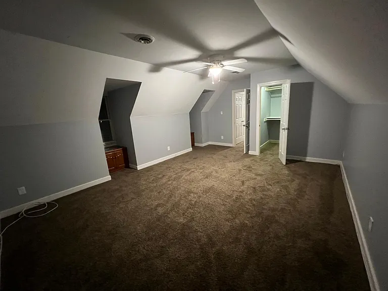 Bedroom 3 located above the garage with walk in closet