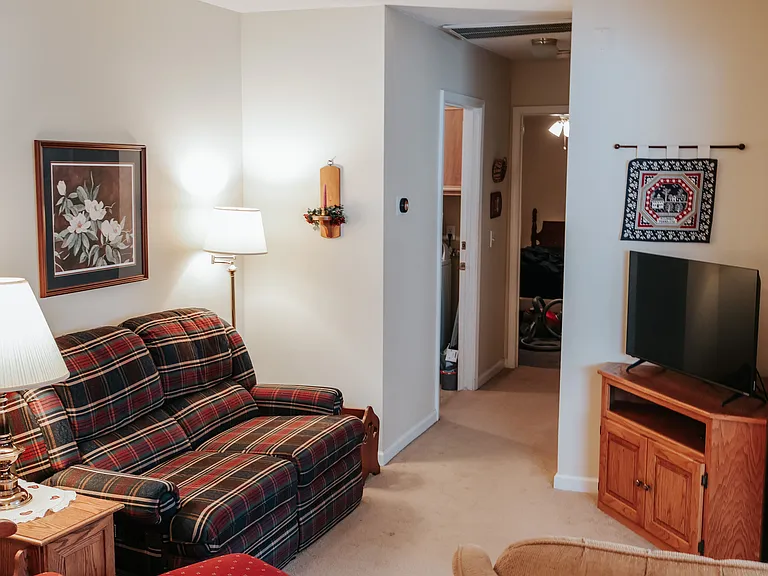 Den, hallway to bedroom. Open door goes to the laundry area, bathroom door is across from it. The Door to the shared laundry has a keyed lock and a deadbolt.