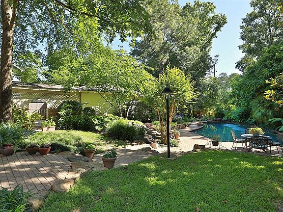 BACK YARD - This is anything but your typical back yard. Mature landscaping provides breathtaking views! Back yard mosquito misting system helps keep it comfortable. There are 3 separate seating areas. Private back yard provides a great place to rela