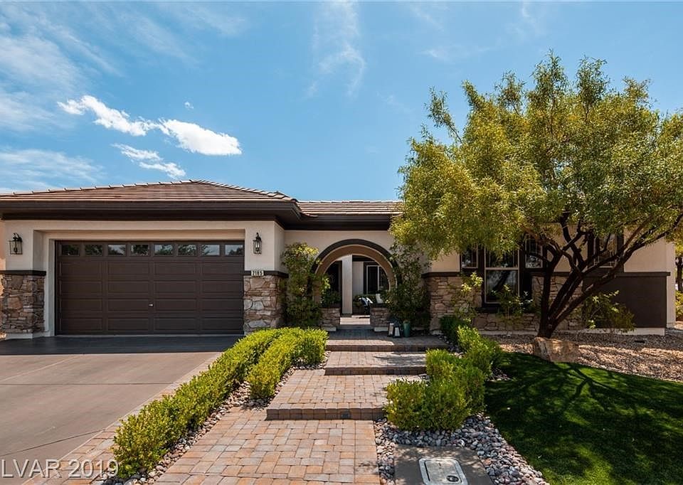 Updated landscaping and hardscape greet you at the entrance to this beautiful home
