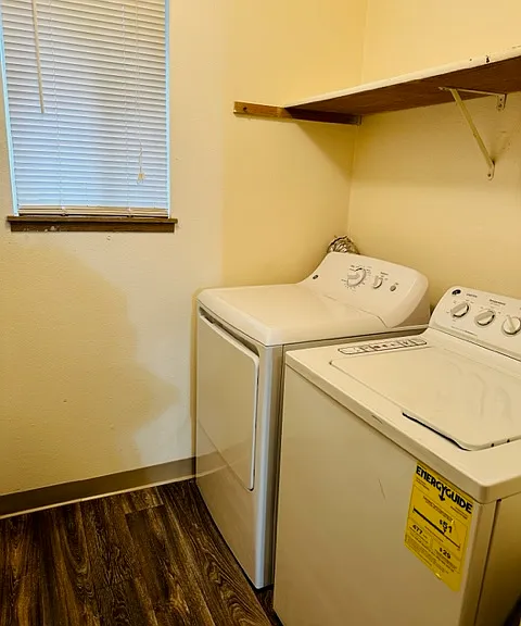 Full sized washer and dryer in laundry room of unit with original finishes